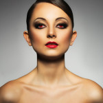 Portrait of a beautiful young woman with a glamorous retro makeu